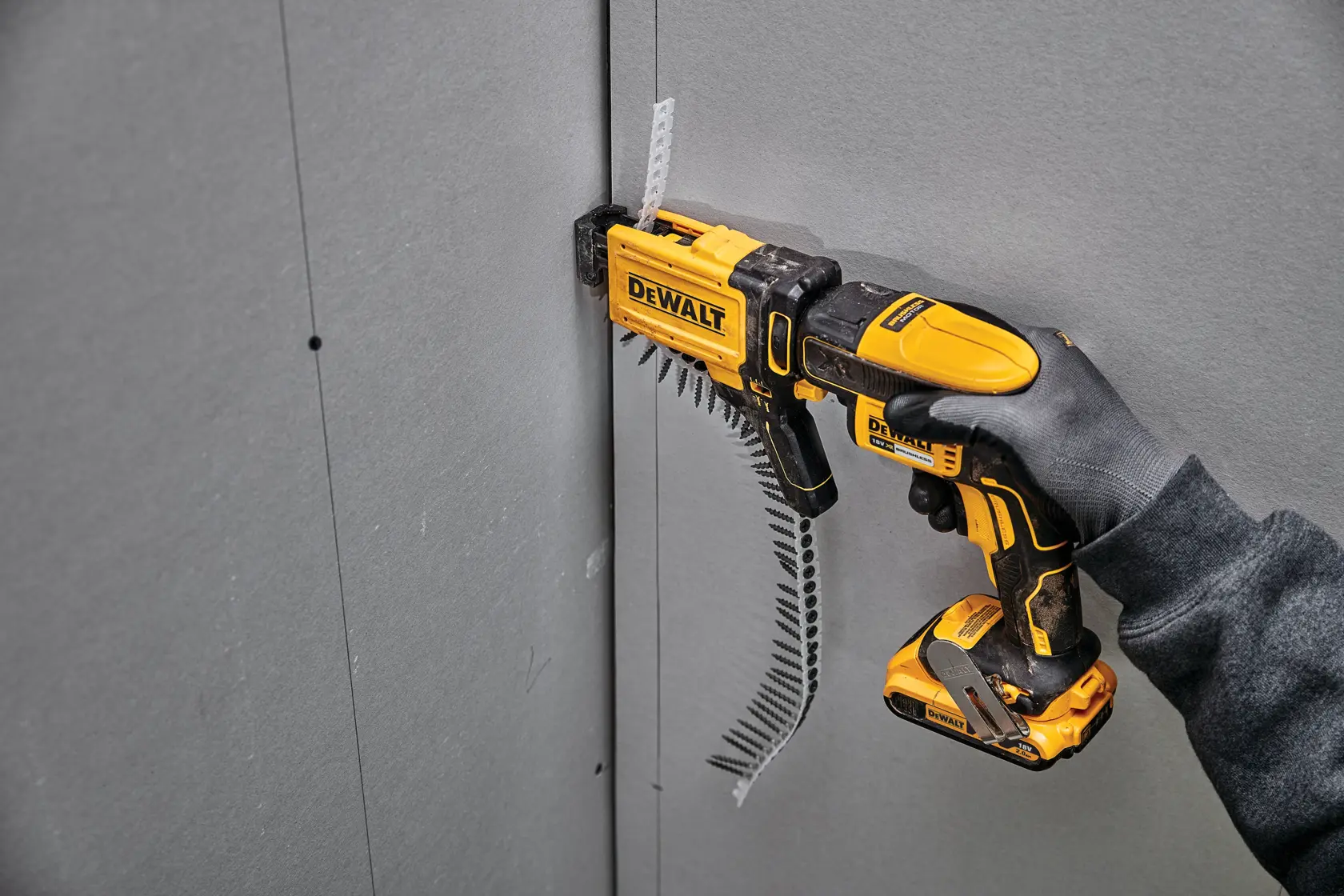 Side view of a DEWALT DCF6202 drywall screw gun attachment designed for use with power tools, featuring a yellow and black handle and casing.